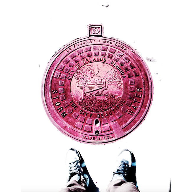Photograph standing over an Orlando manhole